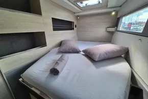 Cozy bedroom interior of 2020 Leopard 45 yacht with skylight and modern design.