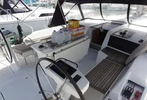 Cockpit of 2020 Beneteau Oceanis 46.1 sailboat with steering wheel and supplies.
