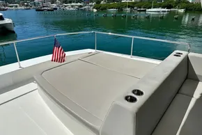 Leopard 53 Powercat 2022 yacht deck with seating and American flag, docked by the water.