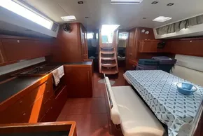 Interior of 2018 Beneteau Oceanis 48 yacht, featuring a cozy dining area and modern kitchen.
