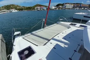 2018 Leopard 45 catamaran docked in a scenic marina with clear blue skies.