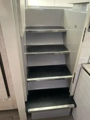 Compact interior stairs in a 2020 Leopard 50 yacht, featuring sleek black steps.