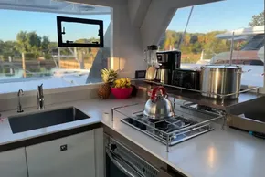 Modern kitchen in 2022 Leopard 42 yacht with appliances and fruit bowl.