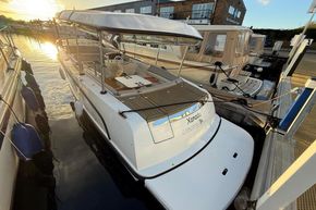 2015 Alfastreet 23 boat docked at marina during sunset, featuring spacious deck and canopy.