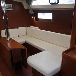 Interior of 2019 Beneteau Oceanis 41.1 yacht with white cushioned seating.