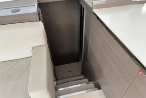 Interior stairs of 2022 Leopard 53 Powercat yacht, featuring modern wood paneling and sleek design.