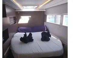 Luxurious cabin interior of 2022 Leopard 45 yacht with modern bedding and ambient lighting.