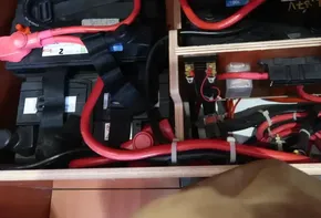 Battery compartment of 2019 Beneteau Oceanis 41.1 with red cables and connectors.