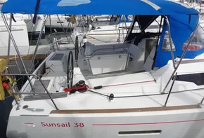 2017 Jeanneau Sun Odyssey 389 sailboat with blue canopy docked at marina.