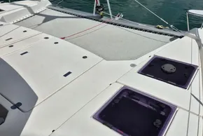 Deck of 2021 Leopard 45 catamaran with hatches and netting over water.