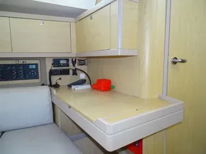 Interior of 2017 Beneteau Oceanis 45 yacht with navigation station and light wood cabinetry.