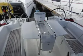 2017 Jeanneau Sun Odyssey 389 cockpit with dual steering wheels and foldable table.