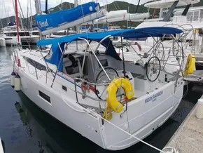 2020 Jeanneau Sun Odyssey 410 sailboat docked, featuring blue canopy and lifebuoys.
