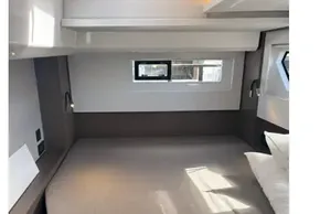 Modern bedroom interior in 2025 Leopard 46 yacht, featuring a cozy bed and sleek design.