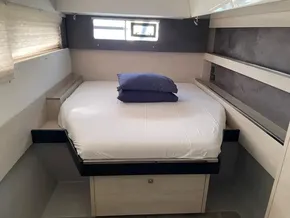 Cozy bedroom in 2020 Leopard 50 yacht with modern design and natural light.
