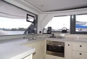 Modern kitchen interior on 2017 Leopard 45 yacht with stove and sink.