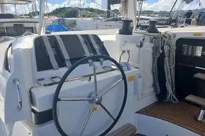 2024 Lagoon 42 yacht helm with steering wheel and navigation equipment.