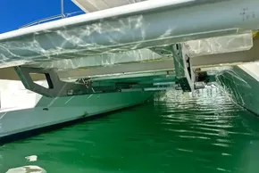 Underwater view of 2022 Leopard 53 Powercat hull and structure in clear green water.