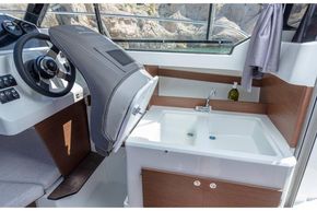 Jeanneau Merry Fisher 605 - helm seat folds forward for access to galley