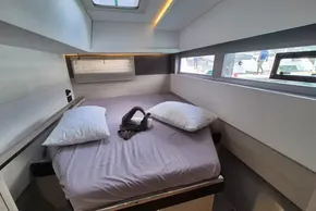 Luxurious cabin interior of 2021 Leopard 45 yacht with modern bedding and ample natural light.