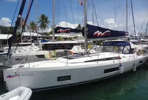 2020 Beneteau Oceanis 46.1 sailboat docked in a marina with palm trees.