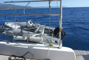Lagoon 42 catamaran with dinghy on deck, sailing in open sea, 2017 model.
