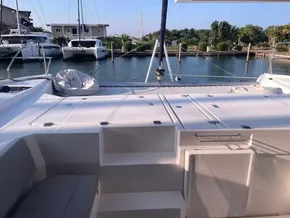 Leopard 45 catamaran, 2021 model, docked at marina with scenic waterfront view.