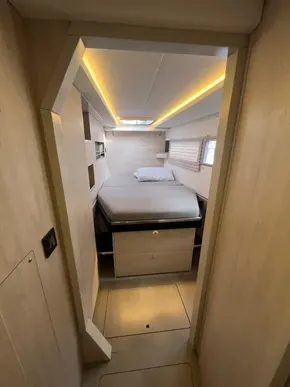 Cozy bedroom in 2019 Leopard 45 yacht with modern lighting and storage.