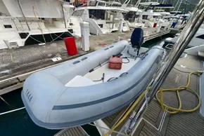 Inflatable boat docked at marina, Leopard 50 model, 2019, with outboard motor and fuel tank.