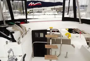 Interior view of 2020 Lagoon 42 catamaran with wooden steps and sailing equipment.