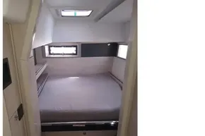 Cozy cabin interior of 2018 Leopard 45 yacht with bed and windows.