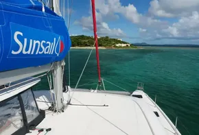 Lagoon 42 catamaran sailing near tropical island, 2020 model.