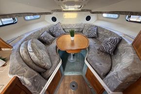 Interior of 1991 Sealine 290 Ambassador with cozy seating and wooden table.