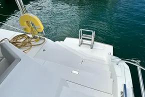 Leopard 50 yacht stern with ladder and life ring, 2021 model, docked on calm water.