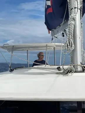 Person sailing a 2020 Leopard 40 catamaran on a sunny day.