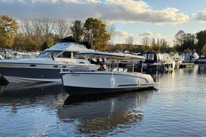 Alfastreet 23 boat from 2015 docked in a serene marina setting.