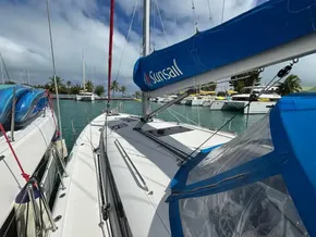 2019 Jeanneau Sun Odyssey 440 sailboat docked in a marina with blue sails.