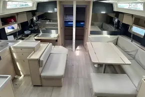 Luxurious interior of 2023 Beneteau Oceanis 51.1 yacht with modern kitchen and seating area.
