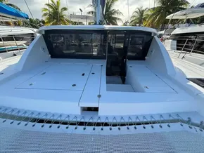 2019 Leopard 40 catamaran deck with open hatches, surrounded by palm trees and other boats.