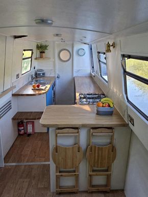 Large kitchen featuring breakfast bar and stools