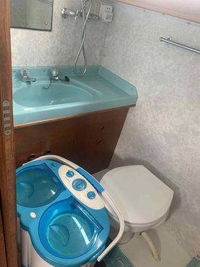 Aft toilet/shower room with camping washing machine