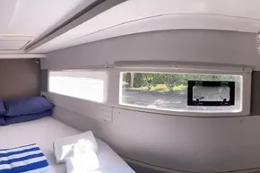 Interior of 2022 Leopard 45 yacht cabin with bed, window, and natural light.