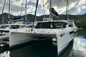 2021 Leopard 50 catamaran docked in a marina, surrounded by scenic mountains.
