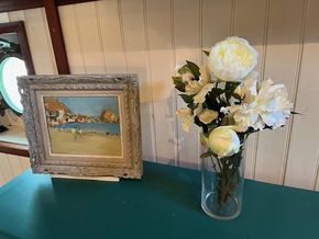 Framed beach painting and white flowers in vase on vintage Dutch barge, 1901.