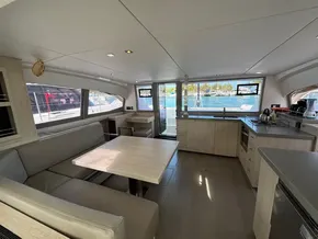 Modern interior of 2019 Leopard 40 catamaran with spacious seating and kitchen area.