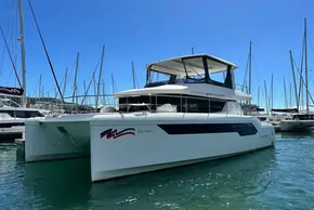 2022 Leopard 53 Powercat yacht docked in marina under clear blue sky.