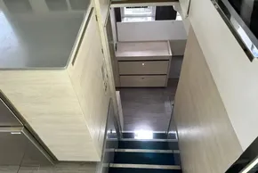 Modern interior of 2021 Leopard 50 yacht, featuring sleek wooden cabinetry and stairs.