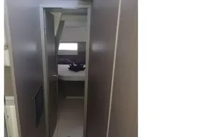 Narrow hallway inside 2022 Leopard 45 yacht, leading to a cozy cabin.