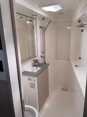 Modern bathroom in a 2020 Leopard 50 yacht, featuring sleek fixtures and ample lighting.
