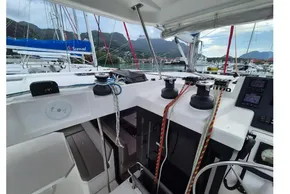 Cockpit of 2020 Leopard 45 catamaran with winches and ropes, docked at marina.